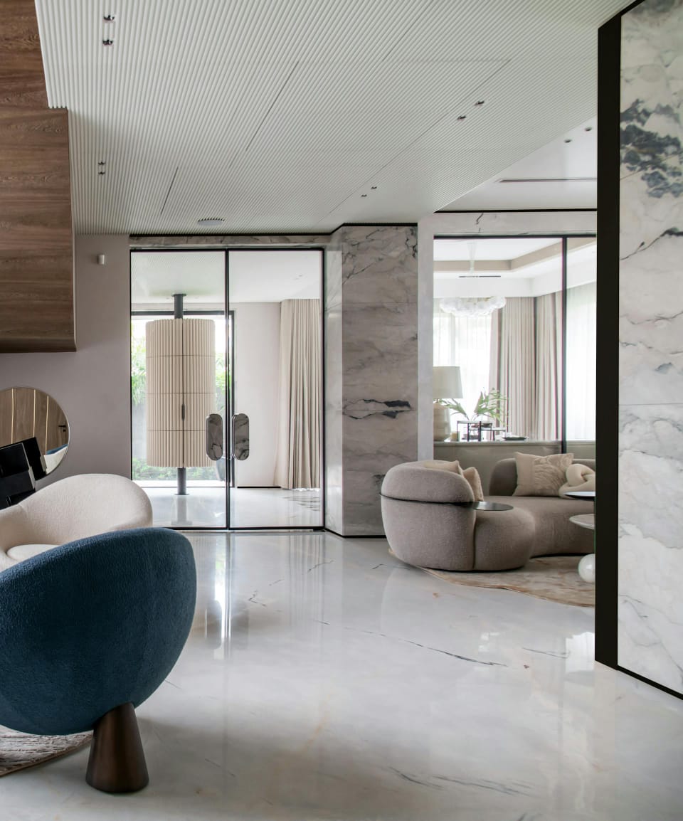 Refined luxury lounge with sculptural seating, calm materials, and elegant spatial flow.