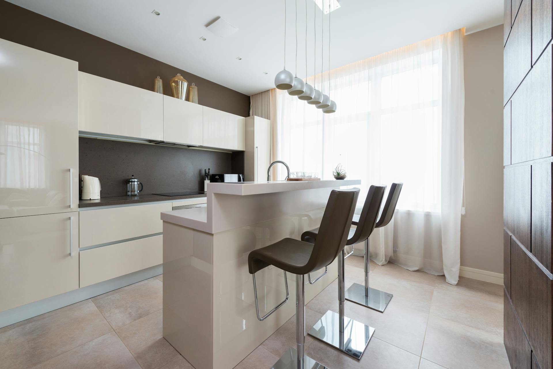 Bright open kitchen and dining interior introducing Ice Interiorr services.