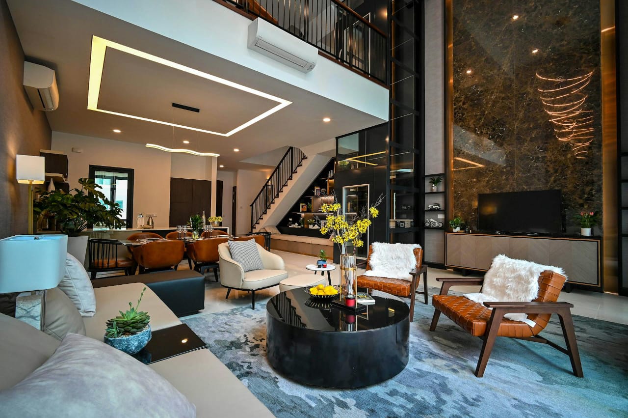 Double-height luxury living room with warm lighting, refined furniture, and a dramatic premium atmosphere.