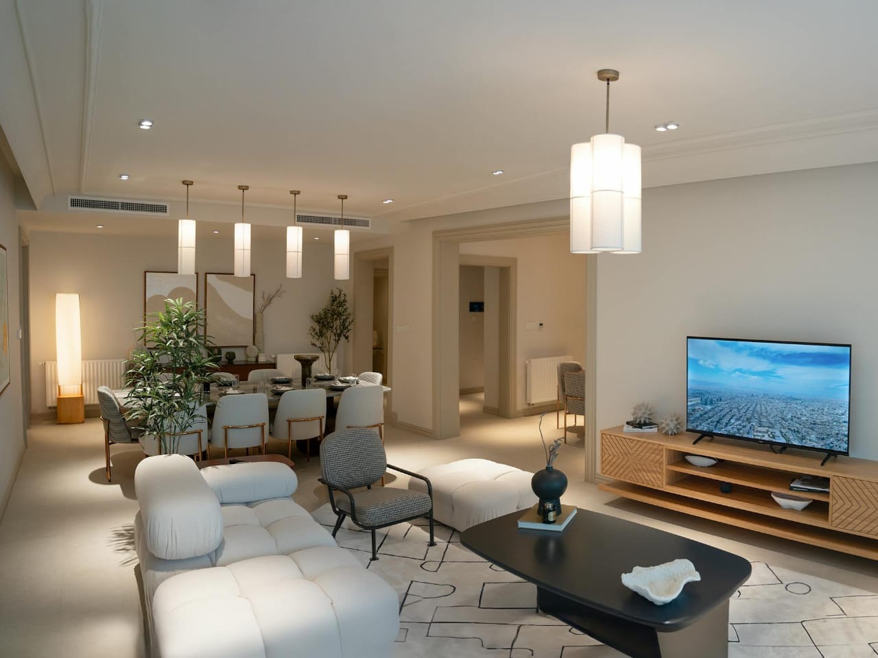 Soft neutral living and dining interior with polished luxury styling.