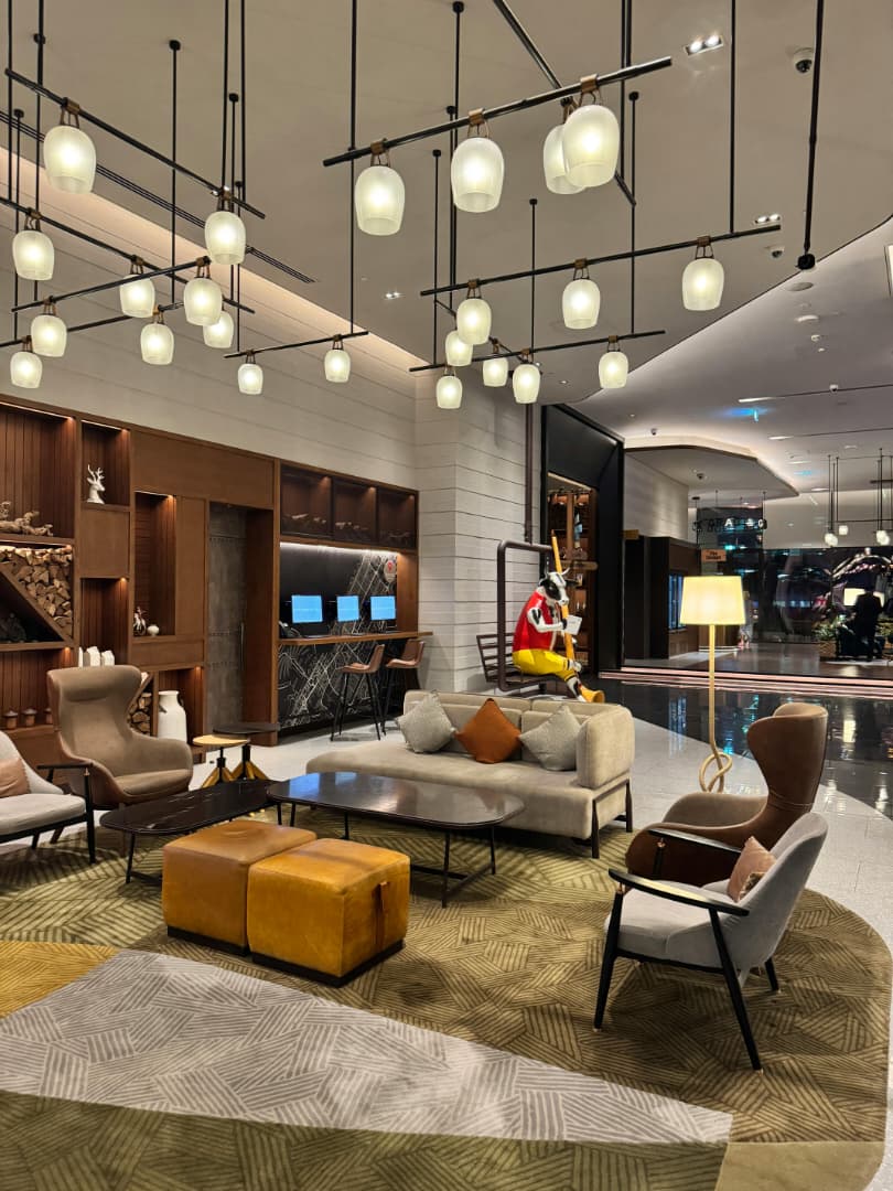 Luxury residential lounge with refined furniture, warm lighting, and layered decor.